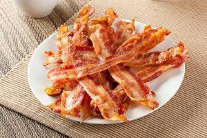 Cooked Greasy Bacon against a back ground