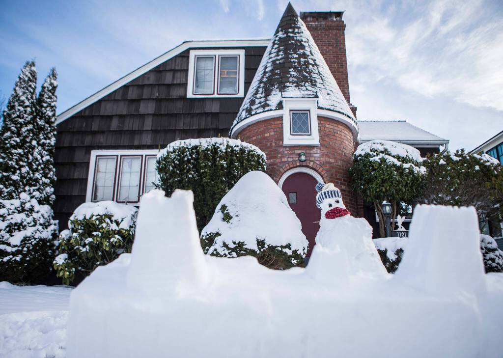 A snow fort created by Sophia Gillette, 10, is visible in front of her home Monday in Everett. (Olivia Vanni / The Herald)