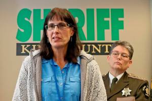 In this 2019 photo, King County Detective Kathleen Decker speaks at a news conference, while Sheriff Mitzi G. Johanknecht looks on, at right, in Seattle. Decker, a now-retired 33-year veteran of the King County Sheriff's Office, made several false statements under oath when she obtained a search warrant in a murder case in 2019, resulting in a man’s false arrest on drug charges, newly unsealed federal court orders show. (Greg Gilbert/The Seattle Times via AP)