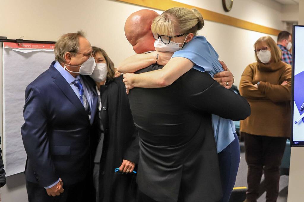 Ryan Leenders (left) and Amber Leenders share a hug after hearing the not guilty verdicts handed down by a jury Thursday afternoon at the Snohomish County Superior Courthouse in Everett. (Kevin Clark / The Herald)