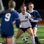 Jacksons Kaeden Hansen and Glacier Peaks Chloe Seelhoff fight for the ball during a game on Oct. 26, 2021 in Snohomish. (Olivia Vanni / The Herald)