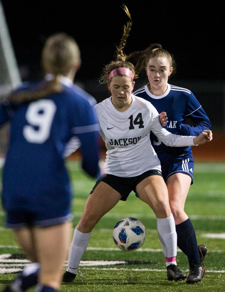 Jacksons Kaeden Hansen and Glacier Peaks Chloe Seelhoff fight for the ball during a game on Oct. 26, 2021 in Snohomish. (Olivia Vanni / The Herald)