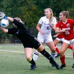 Arlingtons Lexi Miller-Wood blocks a shot with teammate during a match at Archbishop Murphy High School in Everett on Sept. 14, 2021. (Kevin Clark / The Herald)