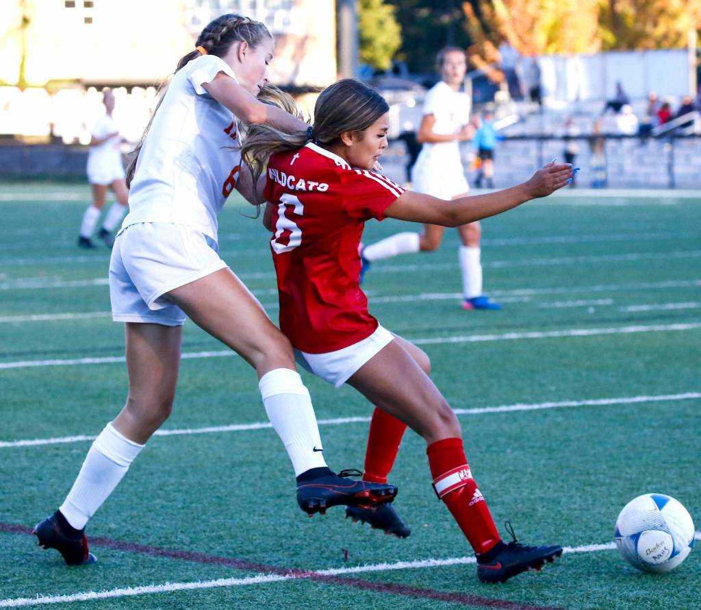 Archbishop Murphys Jojo Chiangpradit (right) is fouled during a game against Monroe at Archbishop Murphy High School in Everett on Sept. 23, 2021. (Kevin Clark / The Herald)