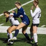 Jacksons Kaelyn Fernandez (left) and Glacier Peaks Ryann Reynolds fight for the ball during a game on Oct. 26, 2021 in Snohomish. (Olivia Vanni / The Herald)