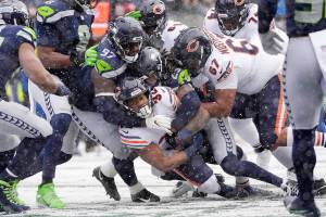 Chicago Bears running back David Montgomery, bottom, scores a touchdown on a carry against the Seattle Seahawks during the first half of an NFL football game, Sunday, Dec. 26, 2021, in Seattle. (AP Photo/Stephen Brashear)