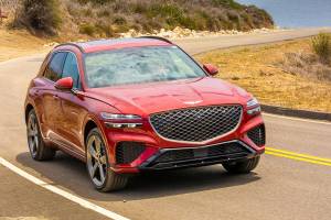 The 2022 Genesis GV70 exhibits a sporty image with its crest grille positioned below the headlamps and a skid plate beneath the bumper. (Manufacturer photo)