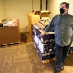 Craig Laughlin with the supplies used for the shelter at Generation Community Church on Wednesday afternoon in Marysville. (Kevin Clark / The Herald)