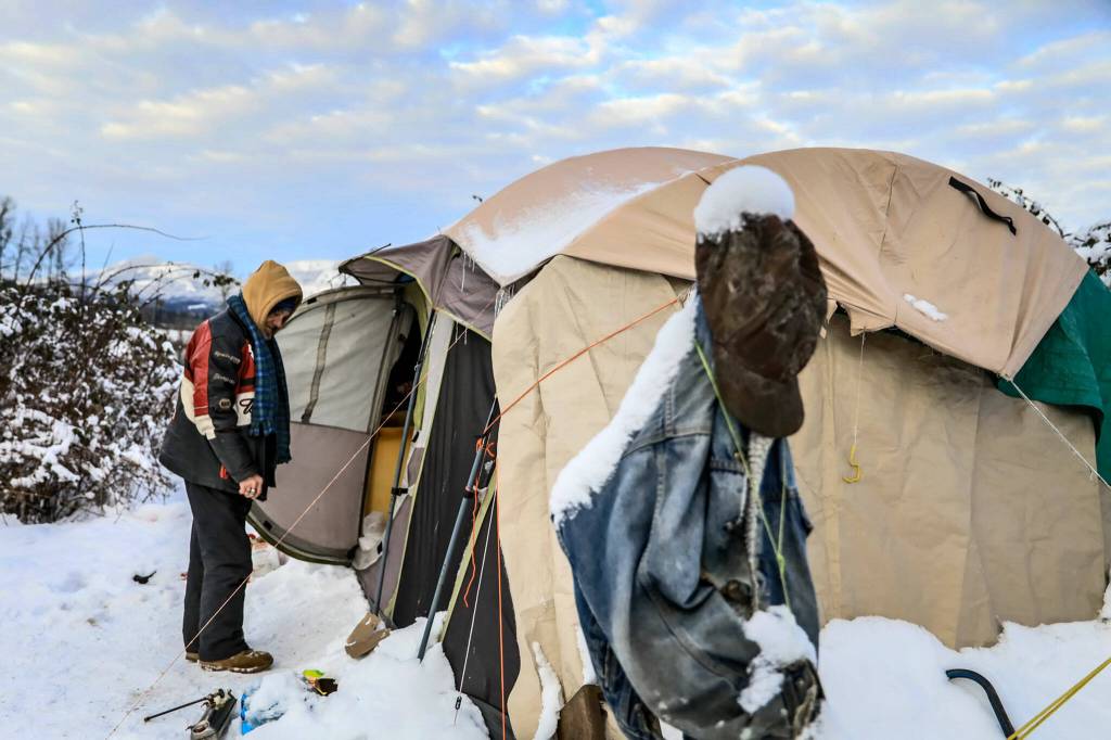 Richard Williams enters the tent he shares with his brother Wednesday afternoon in Arlington. (Kevin Clark / The Herald)