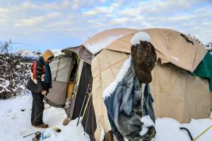 Richard Williams enters the tent he shares with his brother Wednesday afternoon in Arlington on December 29, 2021.  (Kevin Clark / The Herald)