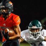 Monroe's Cole Pruett looks for an open lane with Edmonds-Woodway's Nathanuel Marinez closing Friday night at Monroe High School on October 1, 2021.   (Kevin Clark / The Herald)