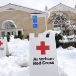 An American Red Cross warming center has been established in Madelyn Helling Library in Nevada City, Calif., Tuesday, Dec. 28, 2021. Snow, ice and unseasonable cold in the Pacific Northwest and the Sierra Nevada are continuing to disrupt traffic, cause closures and force people to find refuge in emergency warming shelters. (Elias Funez/The Union via AP)