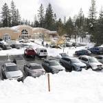 People use the parking lot of the Madelyn Helling Library in Nevada City, Calif., Tuesday , Dec. 28, 2021, to take advantage of the American Red Cross device charging and warming center. Snow, ice and unseasonable cold in the Pacific Northwest and the Sierra Nevada are continuing to disrupt traffic, cause closures and force people to find refuge in emergency warming shelters. (Elias Funez/The Union via AP)