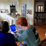Jack Rice (left) gives his grandmother Carolyn Rice a tutorial on her new tablet. (Kevin Clark / The Herald)