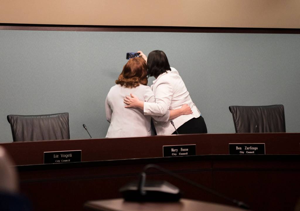 Everett City Councilmembers Mary Fosse and Paula Rhyne take a photograph together after taking their oaths of office Monday in Everett. (Olivia Vanni / The Herald)