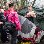 Everett Police officer Inci Yarkut (left) and COET social worker Kelli Roark (center) chat with Chris Portner (right) and his dog Gizzy at his encampment near I-5 and Marine View Drive during the annual Point in Time count Jan. 23, 2019, in Everett. (Olivia Vanni / Herald file)