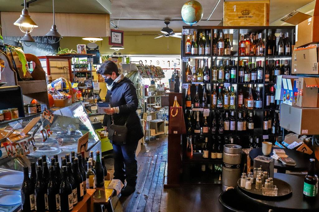 Kim Conn browses the shelves at the Cafe Zippy in Everett on Friday afternoon. (Kevin Clark / The Herald)