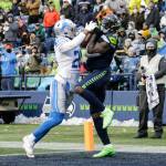 Seattle Seahawks wide receiver DK Metcalf (right) makes a catch for a touchdown in front of Detroit Lions cornerback Ifeatu Melifonwu during the second half of a game Sunday in Seattle. (AP Photo/John Froschauer)
