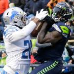 Seattle Seahawks wide receiver DK Metcalf, right, makes a catch for a touchdown in front of Detroit Lions cornerback Ifeatu Melifonwu, left, during the second half of an NFL football game, Sunday, Jan. 2, 2022, in Seattle. (AP Photo/John Froschauer)