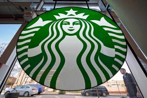 FILE - This is a Starbucks sign in a coffee shop in Pittsburgh, Nov. 13, 2021. Starbucks says its U.S. workers must be fully vaccinated by Feb. 9 or face a weekly COVID testing requirement. The Seattle-based coffee giant said Monday, Jan. 3, 2021 it was acting in response to the Occupational Safety and Health Administration, which issued a vaccine-or-test requirement for companies with more than 100 employees in November. (AP Photo/Gene J. Puskar)