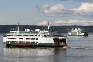 Ferries pass on a crossing between Mukilteo and Whidbey Island in August. (Andy Bronson / Herald file)
