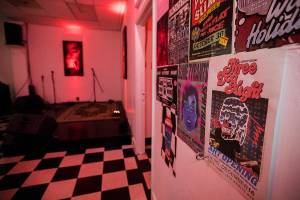 Show posters hang on the wall next to an empty stage at Lucky Dime in Everett. (Olivia Vanni / The Herald)
