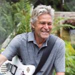 Roger Fisher pauses while jamming in the garden at his Monroe home on July 8, 2021. (Olivia Vanni / The Herald)