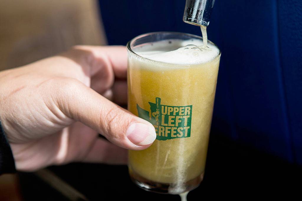 A beer is poured at UpperLeft Beerfest on Aug. 24, 2019 in Everett. (Olivia Vanni / The Herald)