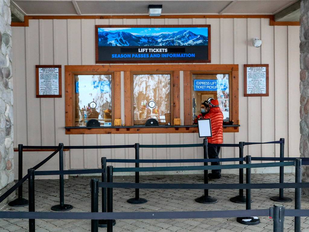 A customer talks with counter representative at Stevens Pass on Dec. 30. (Kevin Clark / The Herald)