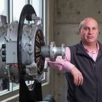 Roei Ganzarski, CEO of magniX, with a production electric engine at the companys office in Everett. (Andy Bronson / Herald file)