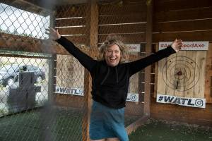 Lisa Riddle jumps for joy after hitting a bullseye on her last throw on a game of axe throwing at Arrowhead Ranch on Thursday, July 15, 2021 in Camano Island, Washington.  (Andy Bronson / The Herald)