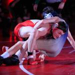 Stanwoods Bryan Roodzant wrestles Arlingtons Ethan Barnett in the 120-pound weight class at Stanwood High School on Thursday evening. (Kevin Clark / The Herald)