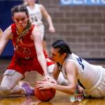Stanwoods Ava Cook, left, and Arlingtons Jenna Villa dive a loose ball at Arlington High School Saturday evening in Arlington, Washington on January 8, 2022. (Kevin Clark / The Herald)