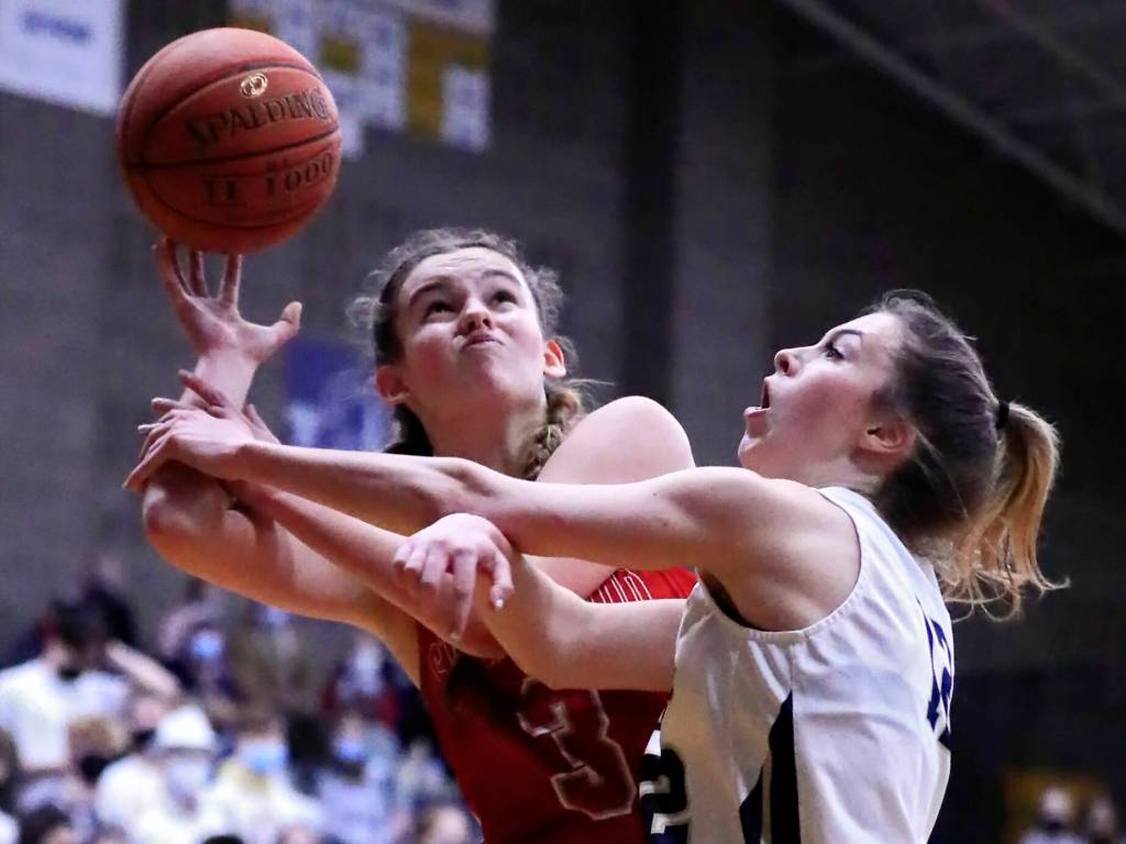 Stanwoods LaTana Swinton, left, attempts a shot with and Arlingtons Hannah Rork fouling at Arlington High School Saturday evening in Arlington, Washington on January 8, 2022. The Eagles won 57-47. (Kevin Clark / The Herald)
