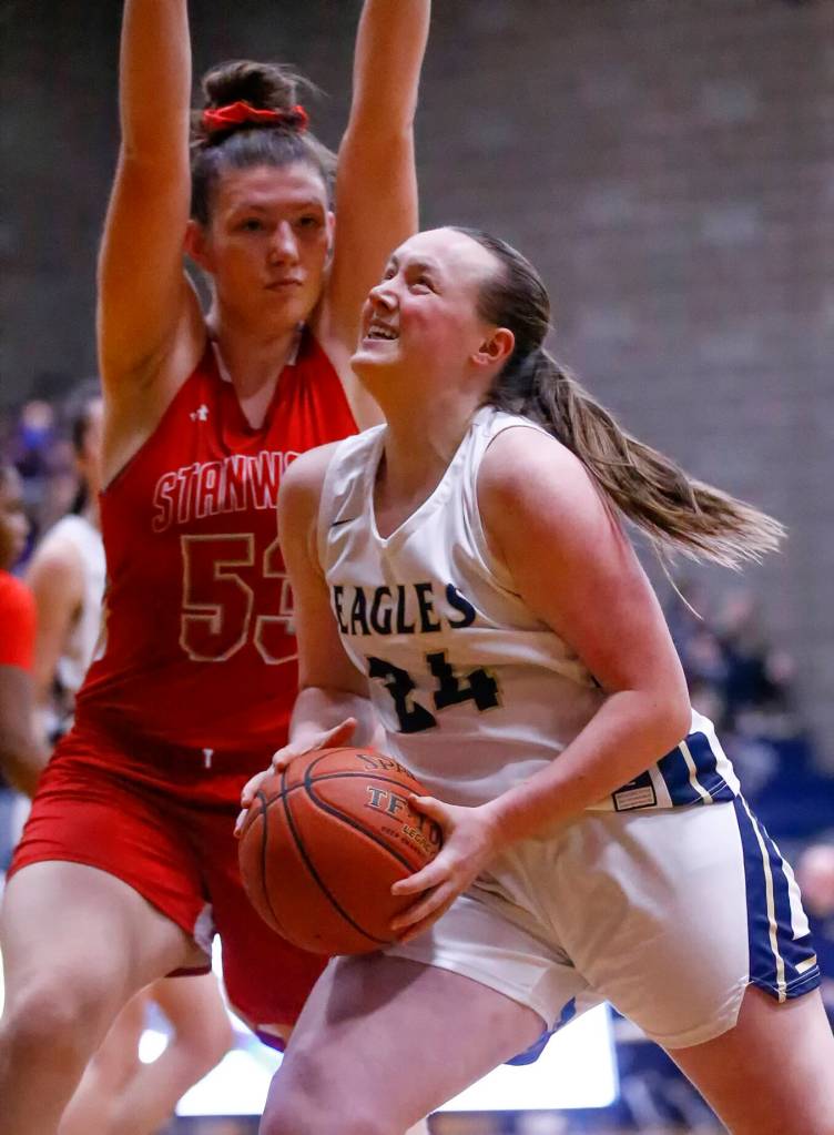 Arlingtons Katie Snow attempts a shot with Stanwoods Vivienne Berrett defending at Arlington High School Saturday evening in Arlington, Washington on January 8, 2022. The Eagles won 57-47. (Kevin Clark / The Herald)