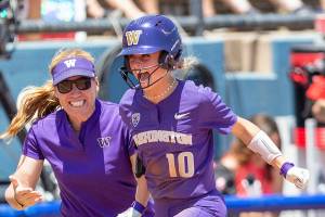 University of Washington freshman Sami Reynolds is congratulated by the Huskies’ head softball coach, Heather Tarr, after hitting a home run in UW’s game against Arizona on May 30 at the Women’s College World Series in Oklahoma City. (University of Washington photo)