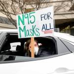 Elementary school teacher Carrie Landheer protests for stronger covid-19 safety protocols outside Oakland Unified School District headquarters on Jan. 7, in Oakland, Calif. Officials across the U.S. are again weighing how and whether to impose mask mandates as covid-19 infections soar and the American public grows weary of pandemic-related restrictions. Much of the debate centers around the nations schools, some of which closed due to infection-related staffing issues. (Noah Berger / Associated Press)