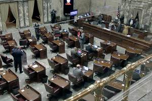 The Washington state Senate is seen on the first day of the 60-day legislative session on Monday, Jan. 10, 2022 in Olympia, Wash. Due to the ongoing COVID-19 pandemic, a limited number of lawmakers are allowed on the chamber floor, with much of the chamber's work being done in a hybrid remote fashion. (AP Photo/Rachel La Corte)