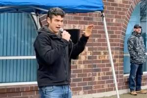 Joe Kent, candidate for U.S. Representative in Washington's 3rd Congressional District, leads a "Rally Against Forced Quarantine" outside a meeting of the Washington State Board of Health in Tumwater on Wednesday. (Joe Kent For Congress / Facebook)