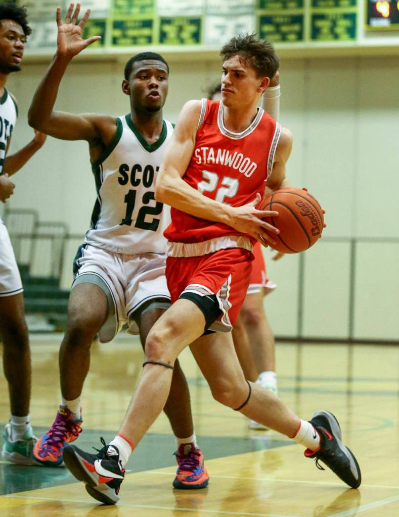 Stanwoods Mack Hepper run the lane looking for a basket against Shorecrests Disma Kagarabi Thursday evening at Shorecrest High School in Shoreline, Washington on January 13, 2022. The Highlanders won 88-68. (Kevin Clark / The Herald)