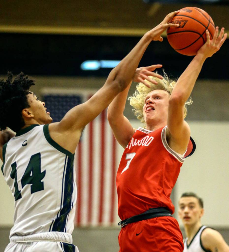 Shorecrests Devon Nehring blocks the shot of Stanwoods Brandt Gilbertson Thursday evening at Shorecrest High School in Shoreline, Washington on January 13, 2022. The Highlanders won 88-68. (Kevin Clark / The Herald)
