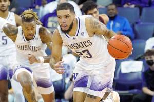 Washington guard Terrell Brown Jr. (23) breaks away after a turnover as Stanford forward Spencer Jones (14) looks on during the first half of an NCAA college basketball game, Saturday, Jan. 15, 2022, in Seattle. (AP Photo/Ted S. Warren)