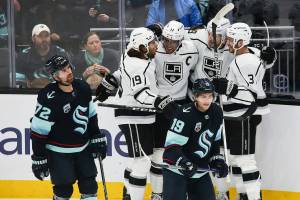 Los Angeles Kings center Adrian Kempe, second from right, celebrates his goal with teammates Alex Iafallo (19), Anze Kopitar, center and Matt Roy (3) as Seattle Kraken right wing Joonas Donskoi (72) and Seattle Kraken center Calle Jarnkrok (19) react during the first period of an NHL hockey game, Saturday, Jan. 15, 2022, in Seattle. (AP Photo/Lindsey Wasson)