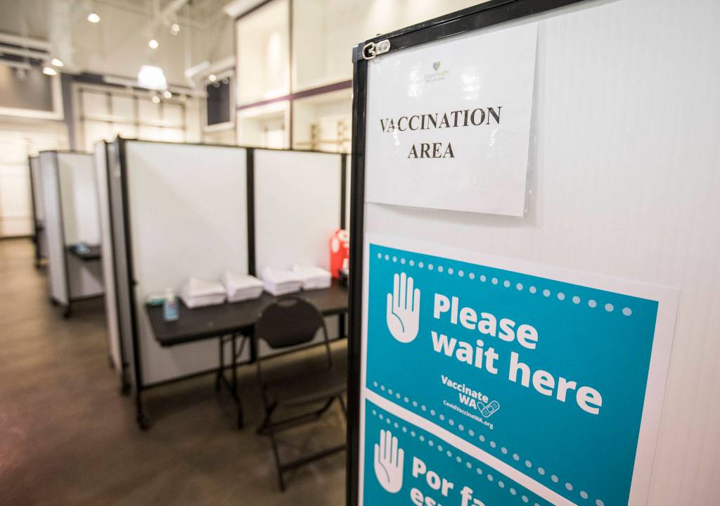 Vaccination stations inside the new free COVID-19 vaccination site at the Everett Mall. (Olivia Vanni / The Herald)