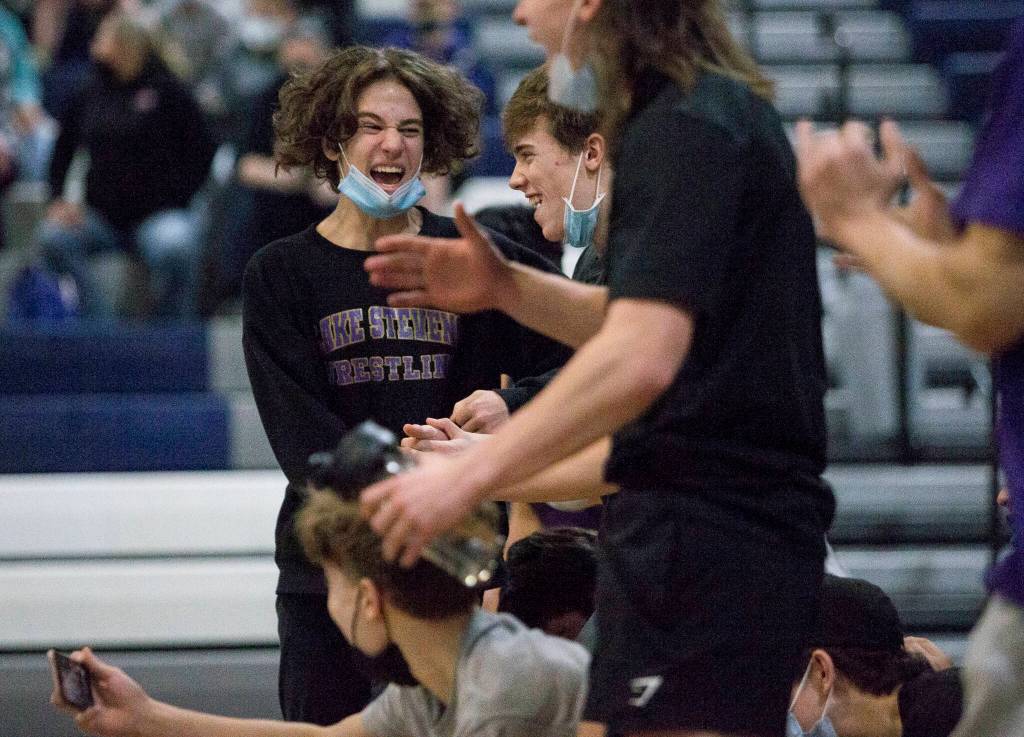 Lake Stevens wrestlers react to winning the match against Glacier Peak on Tuesday in Snohomish. (Olivia Vanni / The Herald)