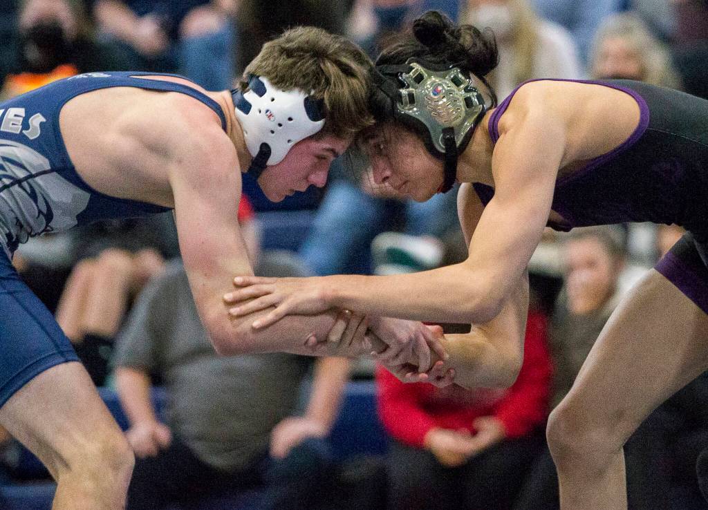 Glacier Peaks Colin Gibbs and Lake Stevens Theron Tate lock hands while wrestling during a match on Tuesday in Snohomish, Washington. (Olivia Vanni / The Herald)