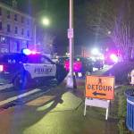 Police respond in downtown Everett after a man collapsed with a gunshot wound Nov. 27. He later died. (Caleb Hutton / Herald file)