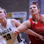 Arlingtons Sophie Willis (left) and Stanwoods Vivienne Berrett battle for a rebound during a game on Jan. 8 at Arlington High School. (Kevin Clark / The Herald)
