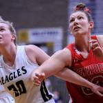Arlington's Sophie Willis, left, and Stanwood's Vivienne Berrett look for a rebound at Arlington High School Saturday evening in Arlington, Washington on January 8, 2022. (Kevin Clark / The Herald)
