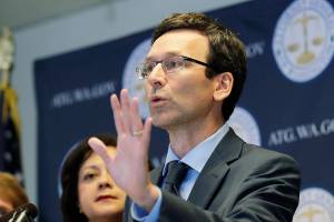 FILE - Washington Attorney General Bob Ferguson talks to reporters, Monday, Aug. 26, 2019, during a news conference in Seattle. In a 5-4 decision Thursday, Jan. 20, 2022, the Washington Supreme Court upheld an $18 million campaign finance penalty against the Consumer Brands Association, formerly known as the Grocery Manufacturers Association. Ferguson sued the group in 2013, alleging that it spent $11 million to oppose a ballot initiative without registering as a political committee or disclosing the source of the money. (AP Photo/Ted S. Warren)